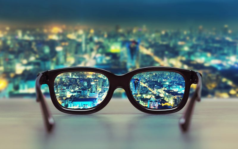 Night cityscape focused in glasses lenses